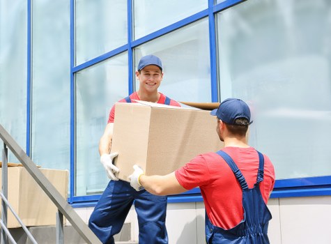 Professional packers carefully wrapping household items in Greenford