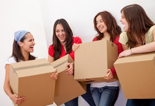 Professional movers handling household furniture