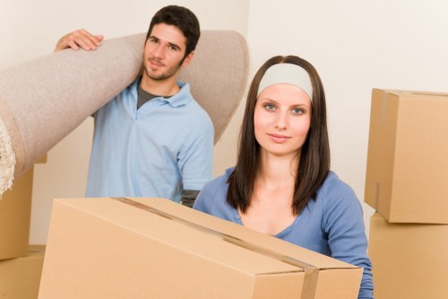 Moving team handling furniture outside a Greenford flat block