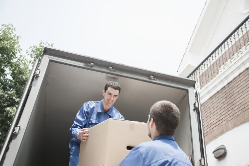 Household moving boxes and furniture being loaded into a van in Greenford